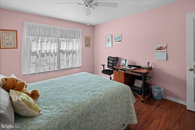 bedroom featuring baseboards, a textured ceiling, ceiling fan, and wood finished floors