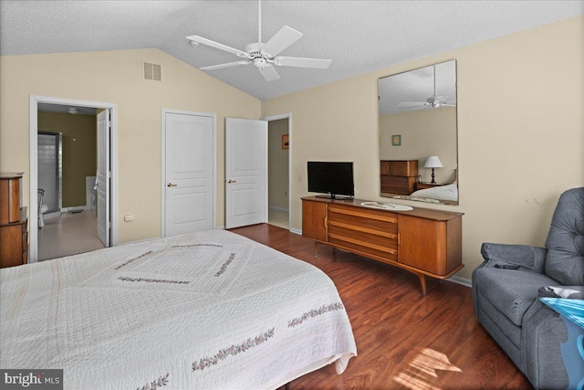 bedroom with wood finished floors, baseboards, lofted ceiling, and visible vents