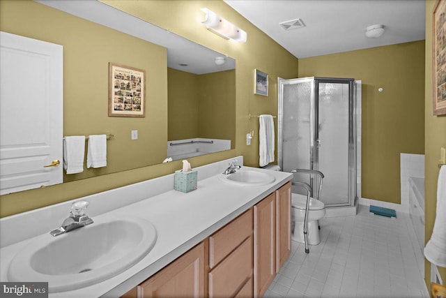 bathroom with a sink, tile patterned floors, a stall shower, and double vanity