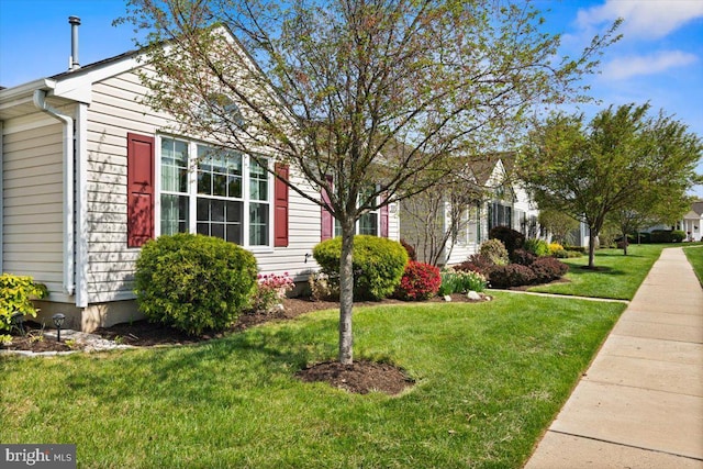 view of side of property with a yard