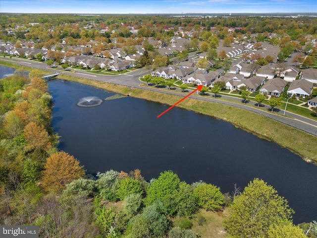 drone / aerial view with a water view and a residential view