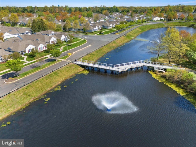drone / aerial view with a residential view and a water view