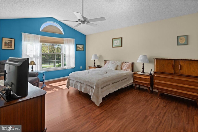 bedroom featuring a textured ceiling, vaulted ceiling, and wood finished floors