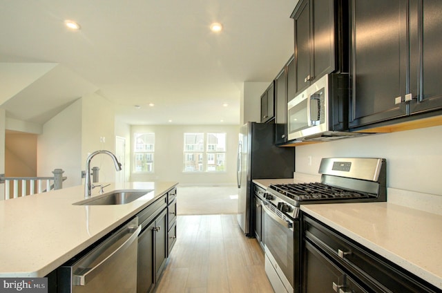 110 Fletcher Cir, Middletown, DE 19709 - kitchen with stainless steel appliances, a sink, light wood finished floors, recessed lighting, and a kitchen island with sink