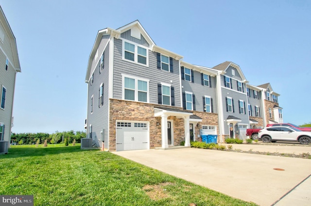 110 Fletcher Cir, Middletown, DE 19709 - multi unit property with stone siding, central AC, a garage, concrete driveway, and a front lawn