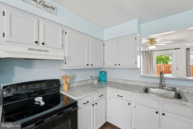 kitchen featuring a sink, white cabinets, under cabinet range hood, and black range with electric cooktop
