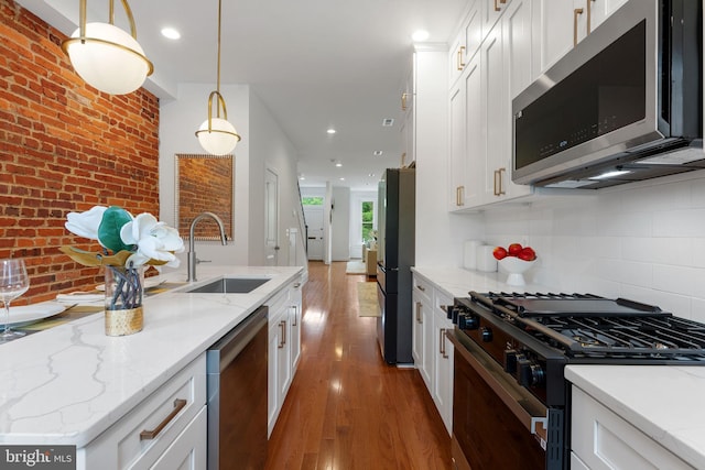 143 13th St NE, Washington, DC 20002 - kitchen with appliances with stainless steel finishes, a sink, wood finished floors, white cabinetry, and recessed lighting
