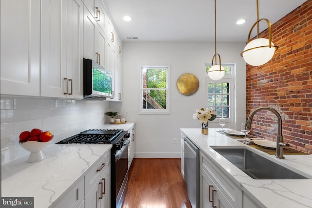143 13th St NE, Washington, DC 20002 - kitchen with appliances with stainless steel finishes, a sink, baseboards, dark wood-style flooring, and pendant lighting