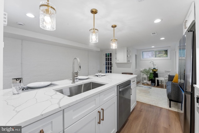 143 13th St NE, Washington, DC 20002 - kitchen with a sink, stainless steel appliances, white cabinets, wood finished floors, and recessed lighting