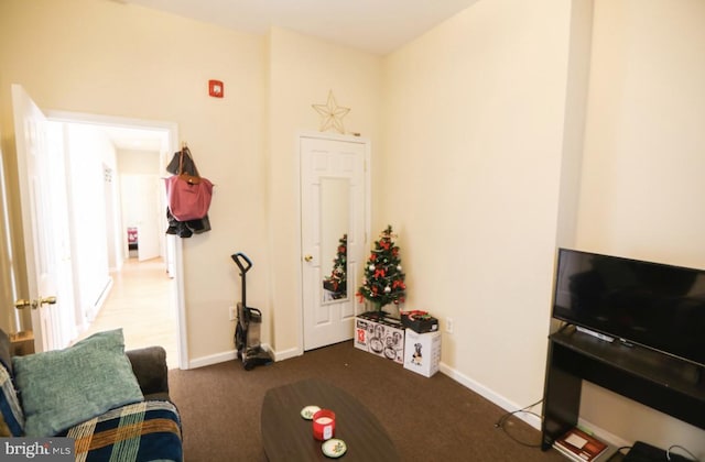 carpeted living room featuring baseboards
