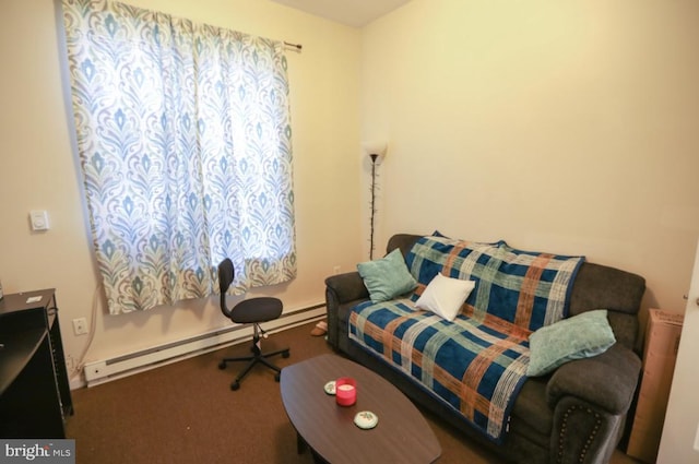 sitting room with baseboard heating and carpet floors