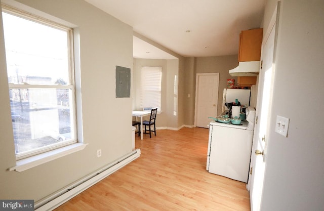 interior space featuring baseboard heating, electric panel, and light wood finished floors