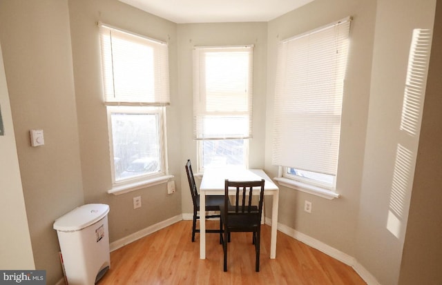 dining room with light wood-style flooring and baseboards