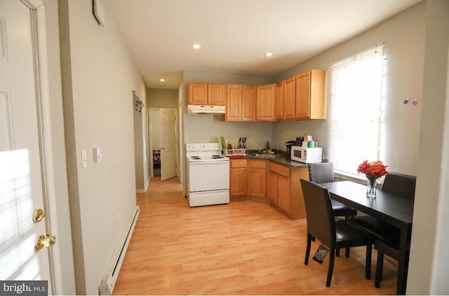 kitchen with a baseboard heating unit, white appliances, light wood finished floors, and a sink