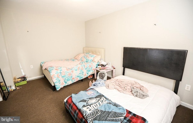 carpeted bedroom featuring baseboards