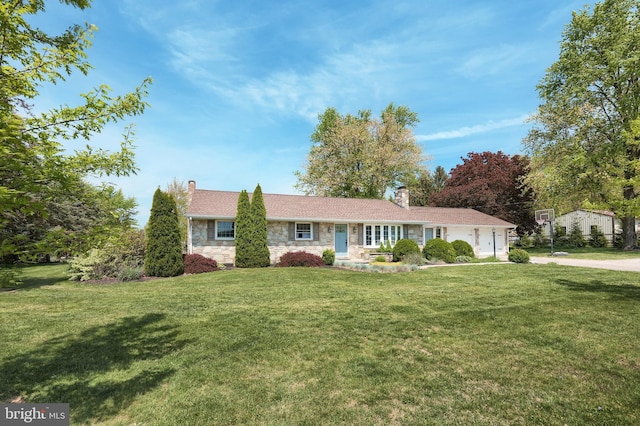 ranch-style home with a garage, a front lawn, stone siding, and a chimney