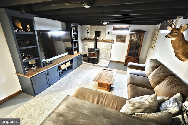 living room with baseboards and a wood stove