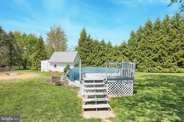 view of yard with a deck and fence