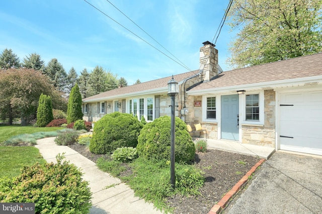 view of front of property featuring stone siding and a chimney