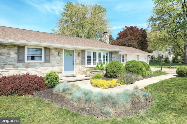 ranch-style home featuring a garage, a chimney, a front lawn, and stone siding