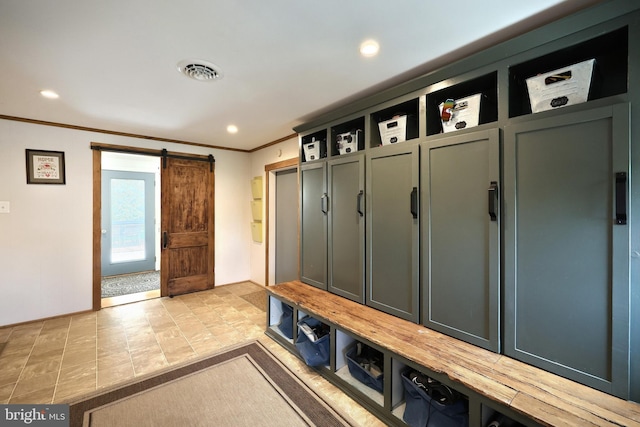 mudroom featuring crown molding, visible vents, recessed lighting, a barn door, and stone finish flooring
