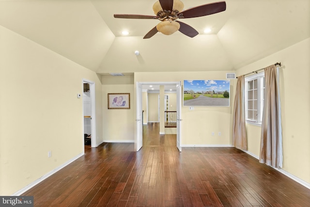 spare room featuring lofted ceiling, dark wood-style flooring, visible vents, and ceiling fan