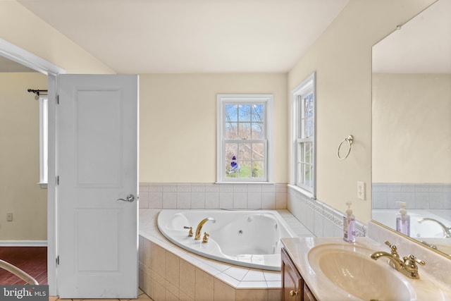 bathroom with a jetted tub and vanity