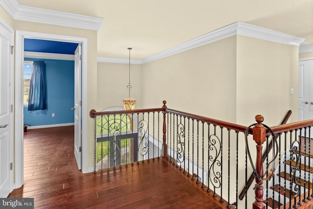 hall featuring crown molding, an upstairs landing, hardwood / wood-style flooring, and baseboards