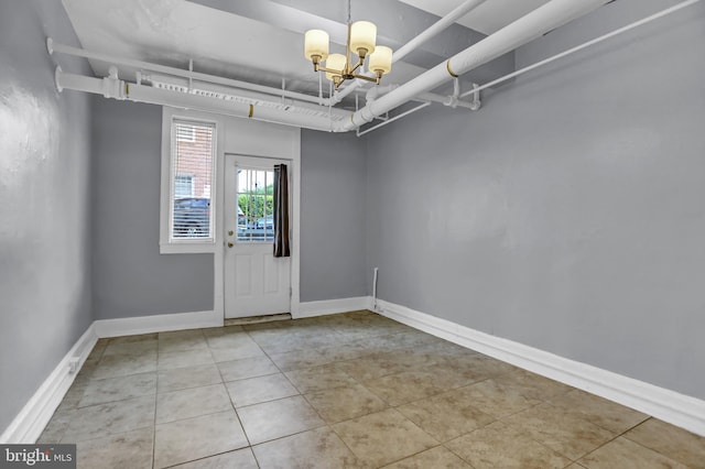 101 W 39th St Unit 101, Baltimore, MD 21210 - entrance foyer with an inviting chandelier, baseboards, and tile patterned flooring