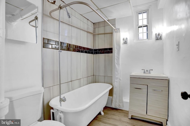 101 W 39th St Unit 101, Baltimore, MD 21210 - bathroom with a shower with curtain, wood finished floors, a sink, toilet, and a soaking tub
