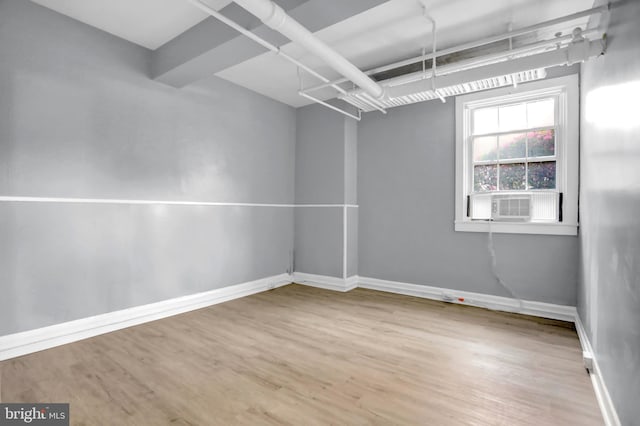 101 W 39th St Unit 101, Baltimore, MD 21210 - empty room featuring baseboards, cooling unit, and wood finished floors