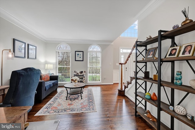 living room featuring crown molding, stairs, wood finished floors, and plenty of natural light