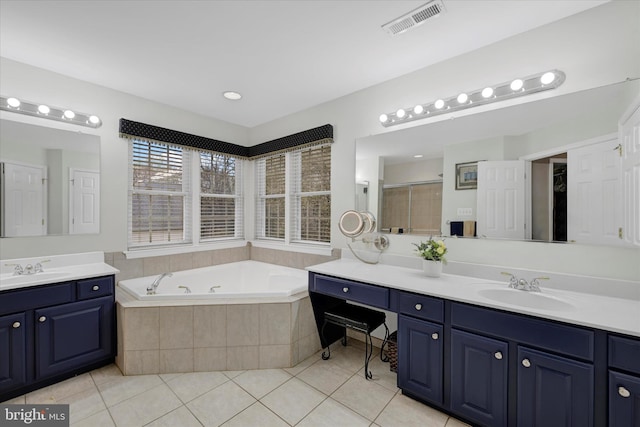 bathroom featuring visible vents, a whirlpool tub, tile patterned flooring, and a sink