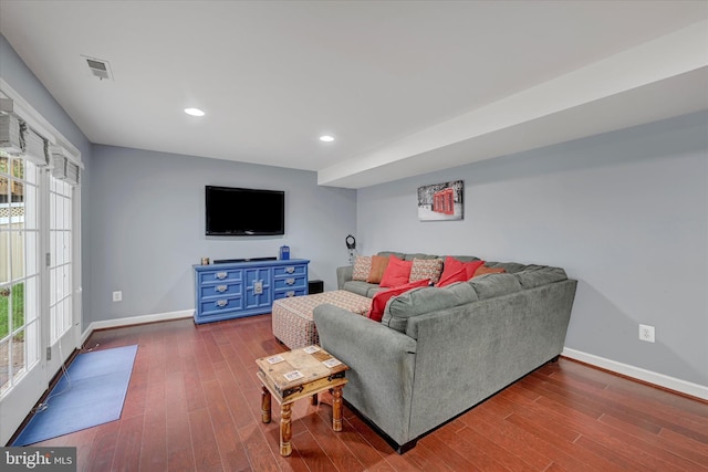 living room featuring baseboards, visible vents, and dark wood finished floors