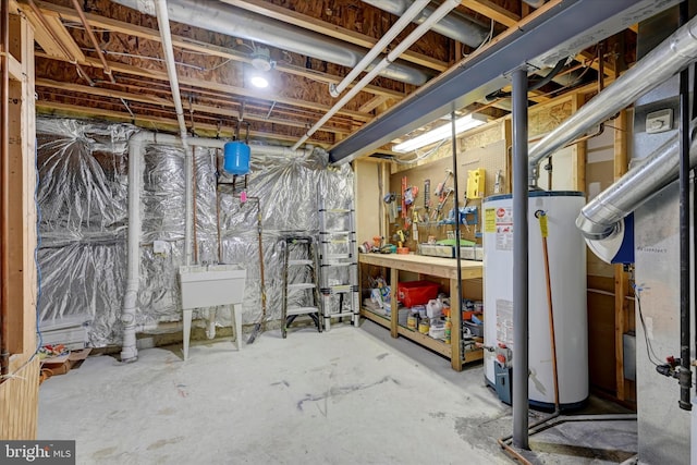 unfinished basement with gas water heater and a sink