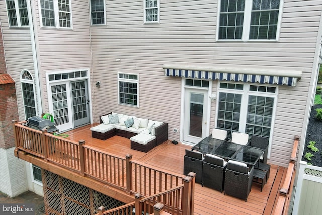 wooden deck with an outdoor living space