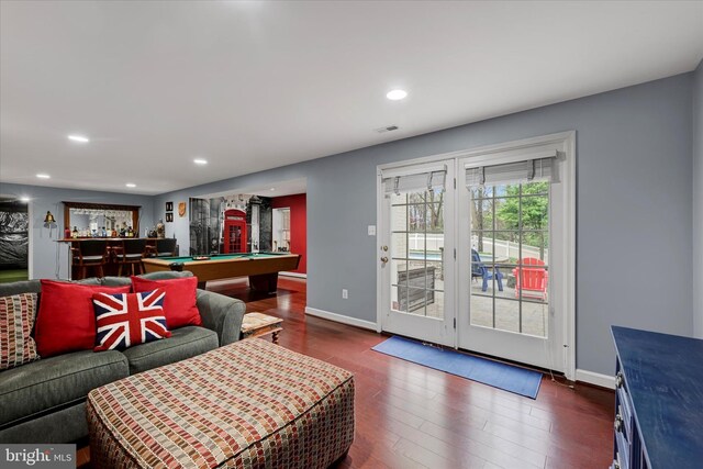living room featuring dark wood-style flooring, visible vents, baseboards, and pool table