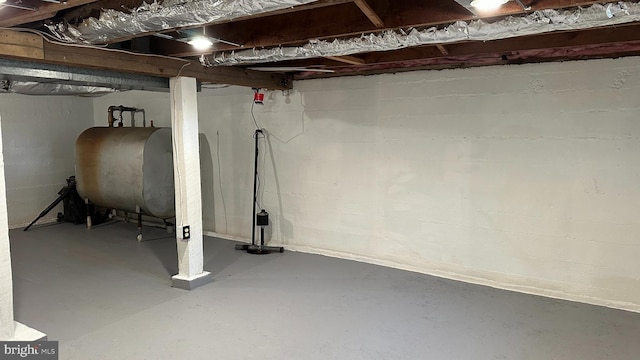 unfinished basement featuring heating fuel