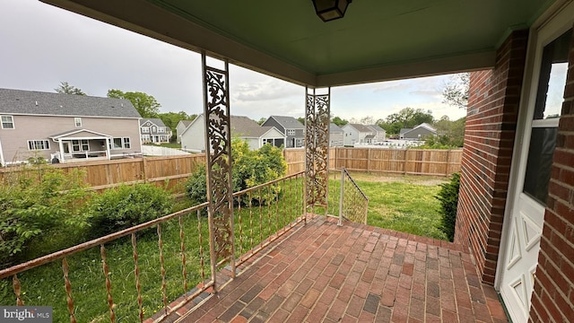 view of patio featuring a fenced backyard and a residential view