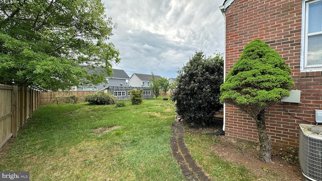 view of yard featuring fence and cooling unit