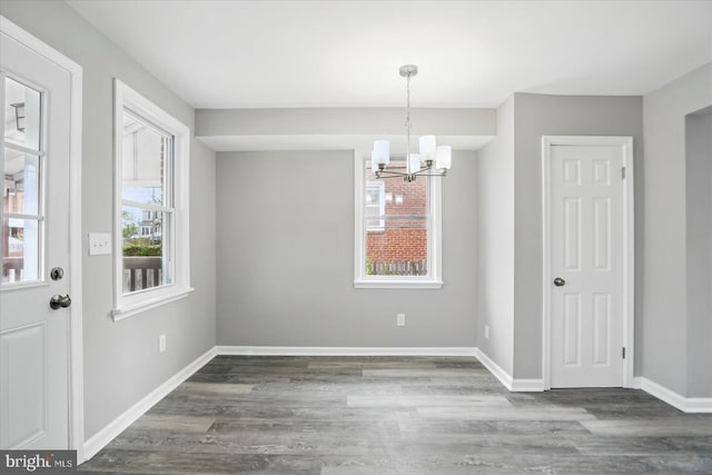 1212 Primrose Ave, Baltimore, MD 21237 - unfurnished dining area featuring a notable chandelier, wood finished floors, and baseboards