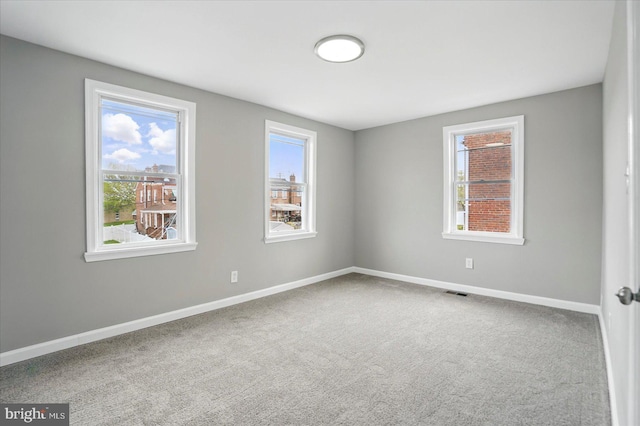 1212 Primrose Ave, Baltimore, MD 21237 - spare room featuring visible vents, plenty of natural light, carpet flooring, and baseboards