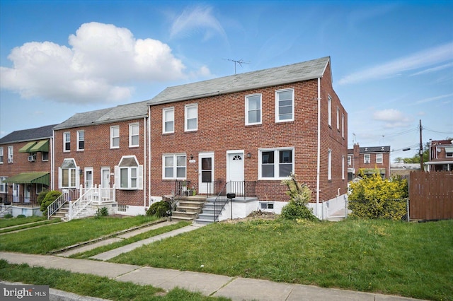 1212 Primrose Ave, Baltimore, MD 21237 - view of property with a front lawn, fence, and brick siding
