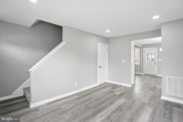 1212 Primrose Ave, Baltimore, MD 21237 - unfurnished living room featuring recessed lighting, wood finished floors, stairs, baseboards, and visible vents