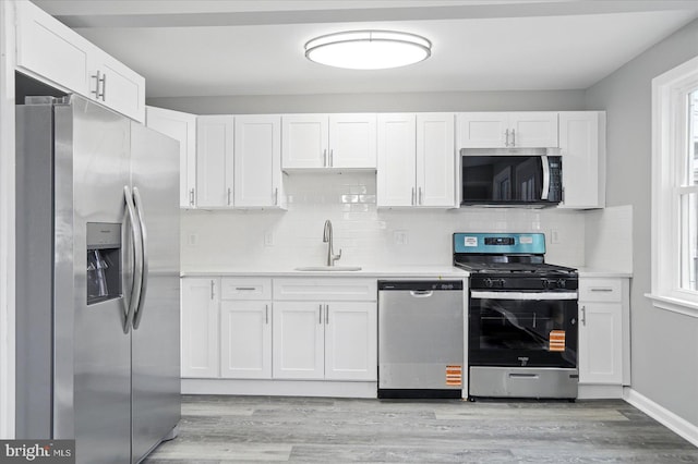 1212 Primrose Ave, Baltimore, MD 21237 - kitchen with light wood-style floors, stainless steel appliances, light countertops, and a sink