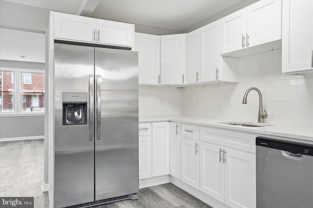 1212 Primrose Ave, Baltimore, MD 21237 - kitchen with white cabinetry, light wood-type flooring, stainless steel appliances, and a sink
