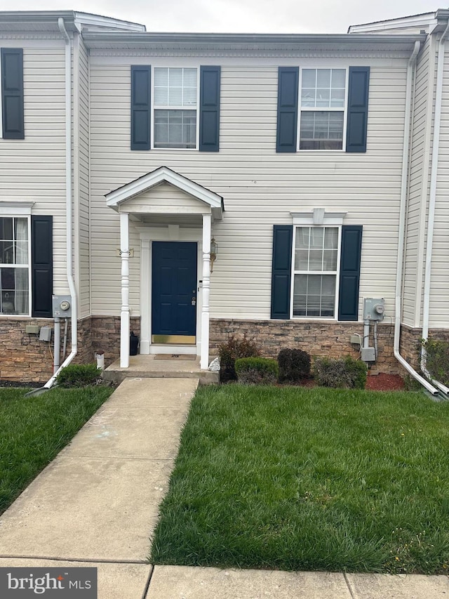 view of front of property featuring a front yard and stone siding