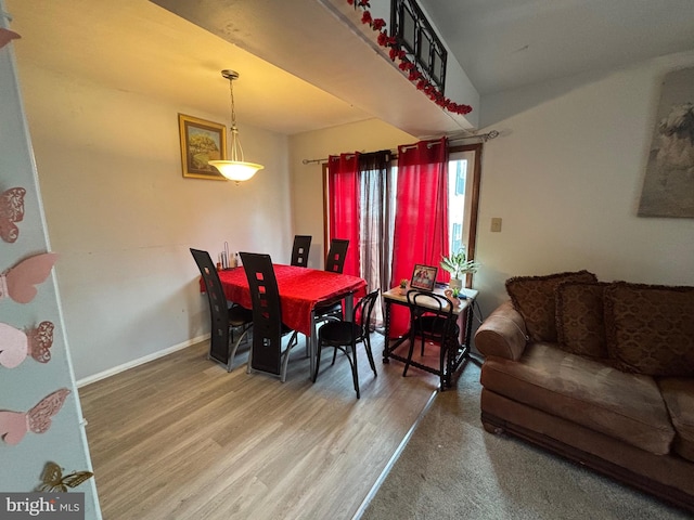 dining room featuring wood finished floors and baseboards