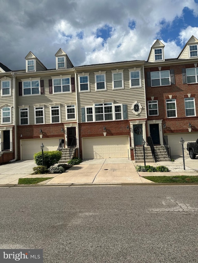 724 Hidden Oak Ln, Glen Burnie, MD 21060 - townhome / multi-family property with brick siding, driveway, and a garage