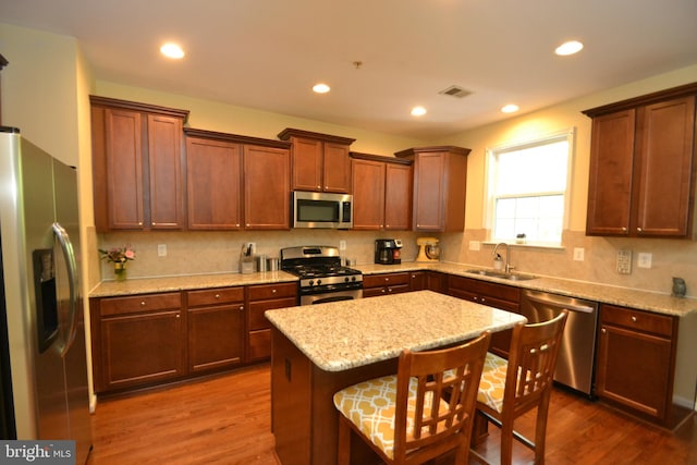 724 Hidden Oak Ln, Glen Burnie, MD 21060 - kitchen featuring visible vents, dark wood-type flooring, tasteful backsplash, a sink, and appliances with stainless steel finishes